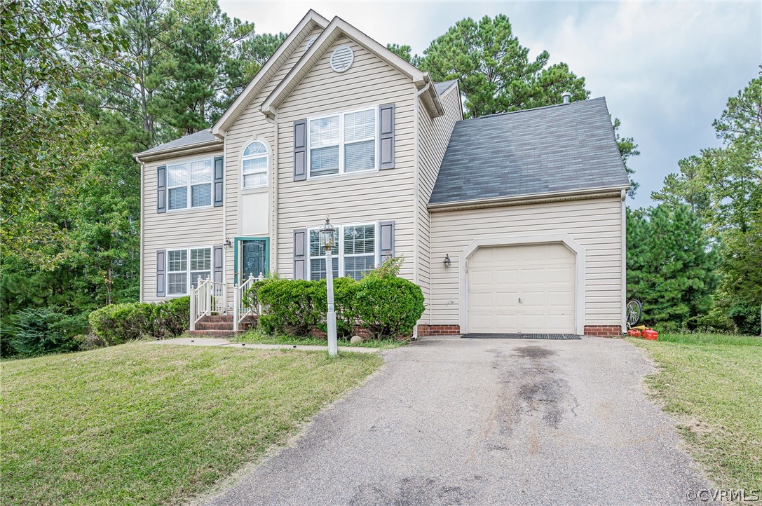264 Scotch Pine Drive Sandston, VA 23150 - Photo 3 of 26 a front view of a house with garden