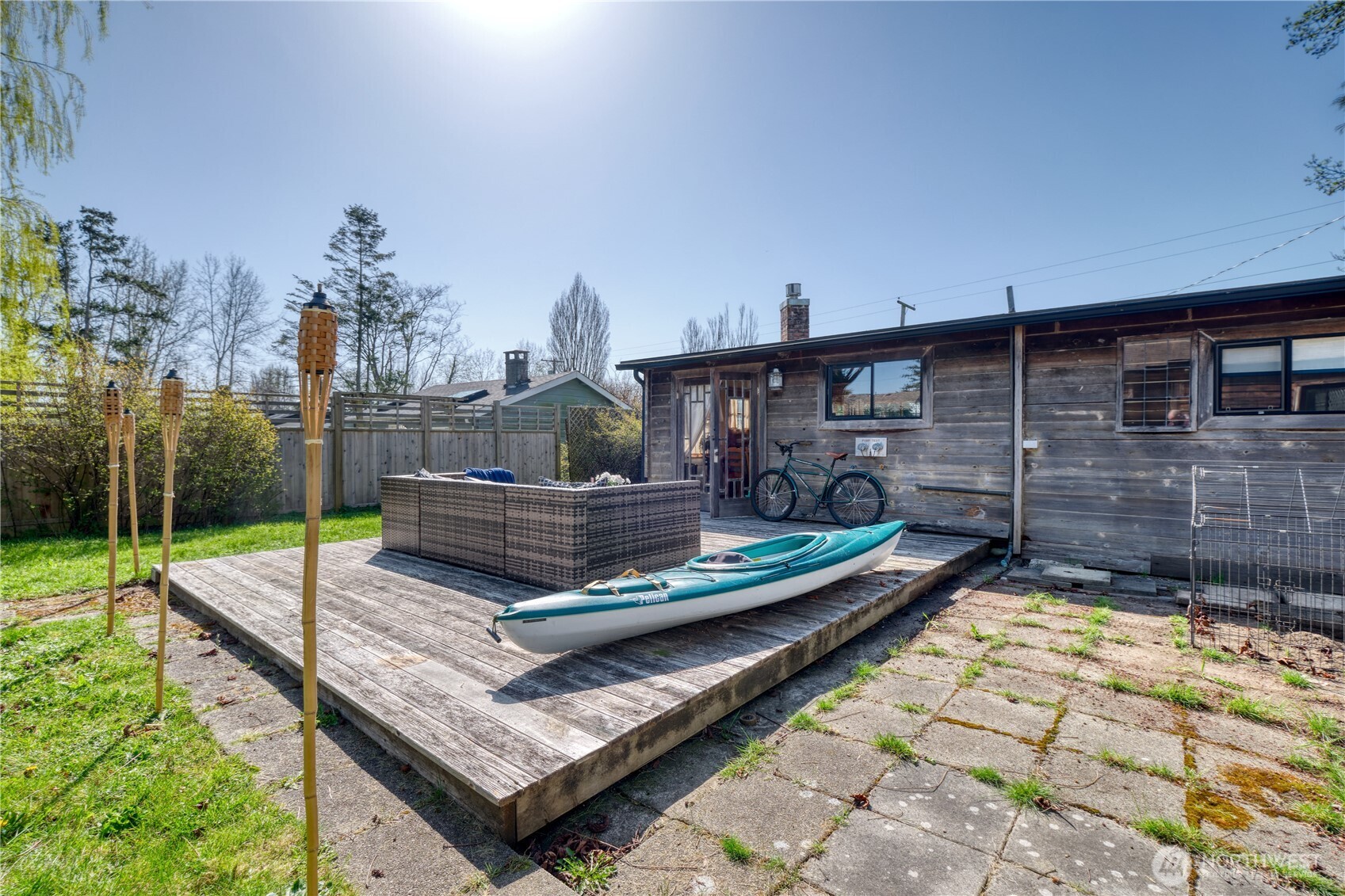 684 Mallard Drive Point Roberts, WA 98281 - Photo 35 of 37 a view of a chair and tables in the patio with a yard
