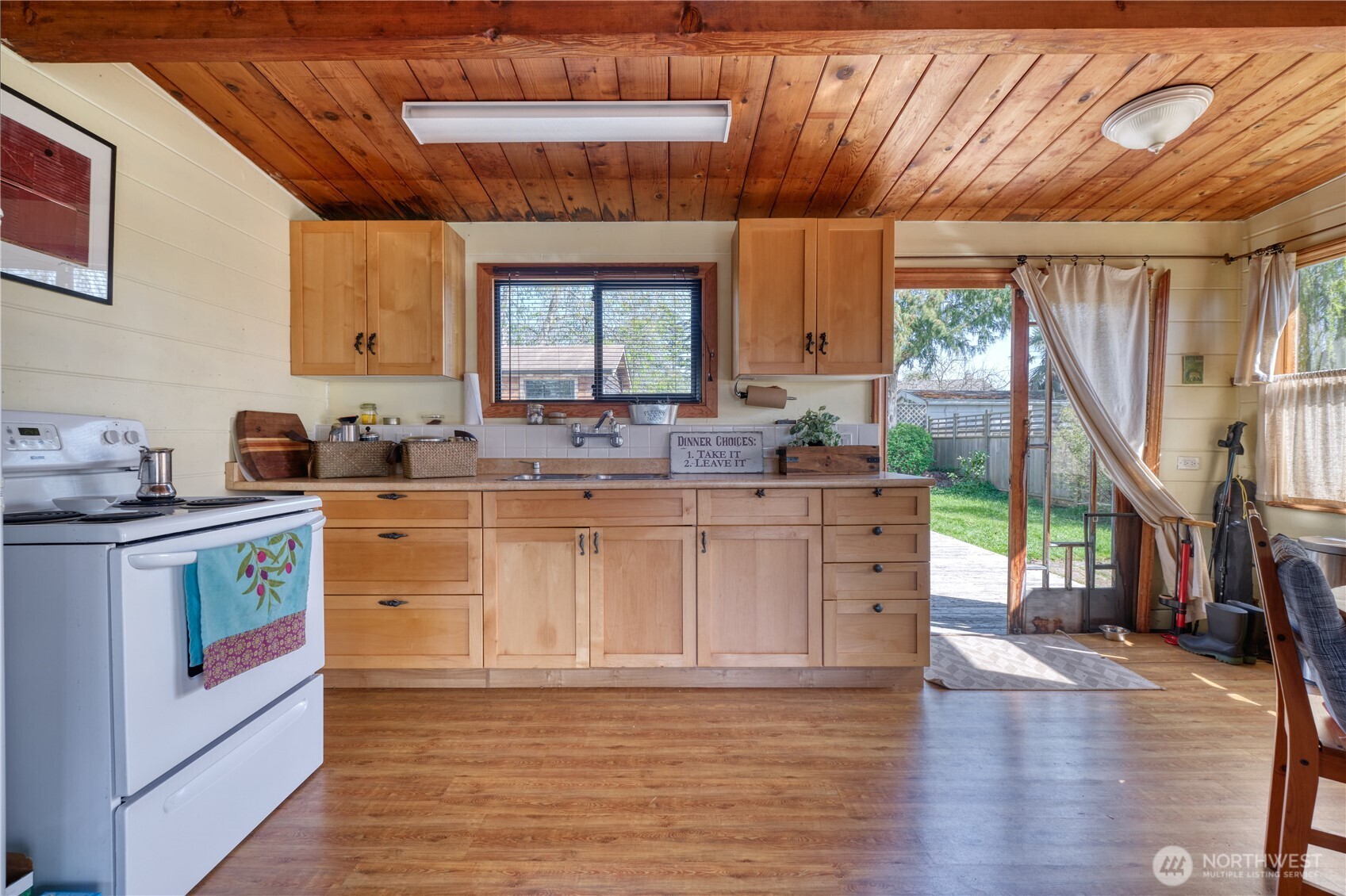 684 Mallard Drive Point Roberts, WA 98281 - Photo 5 of 37 a kitchen with stainless steel appliances granite countertop a sink a stove cabinets counter space and a window