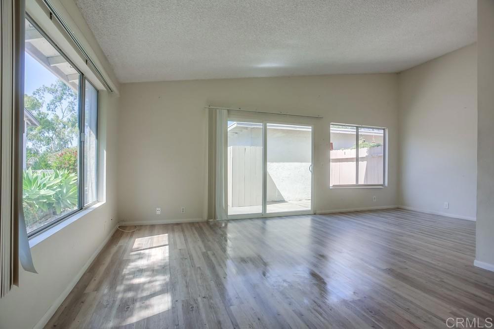 3538 Sandpiper Place Oceanside, CA 92056 - Photo 3 of 16 a view of an empty room with wooden floor and a window