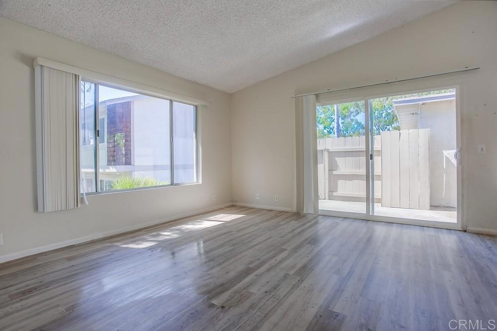 3538 Sandpiper Place Oceanside, CA 92056 - Photo 4 of 16 a view of an empty room with wooden floor and a window