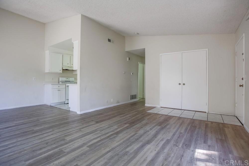 3538 Sandpiper Place Oceanside, CA 92056 - Photo 5 of 16 a view of an empty room with wooden floor and a window