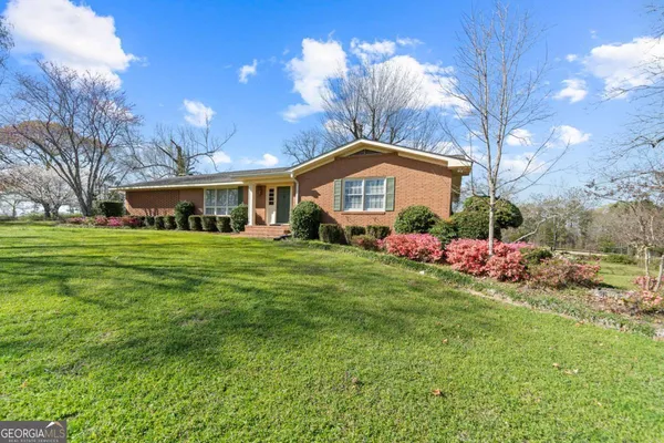 a front view of house with yard and green space