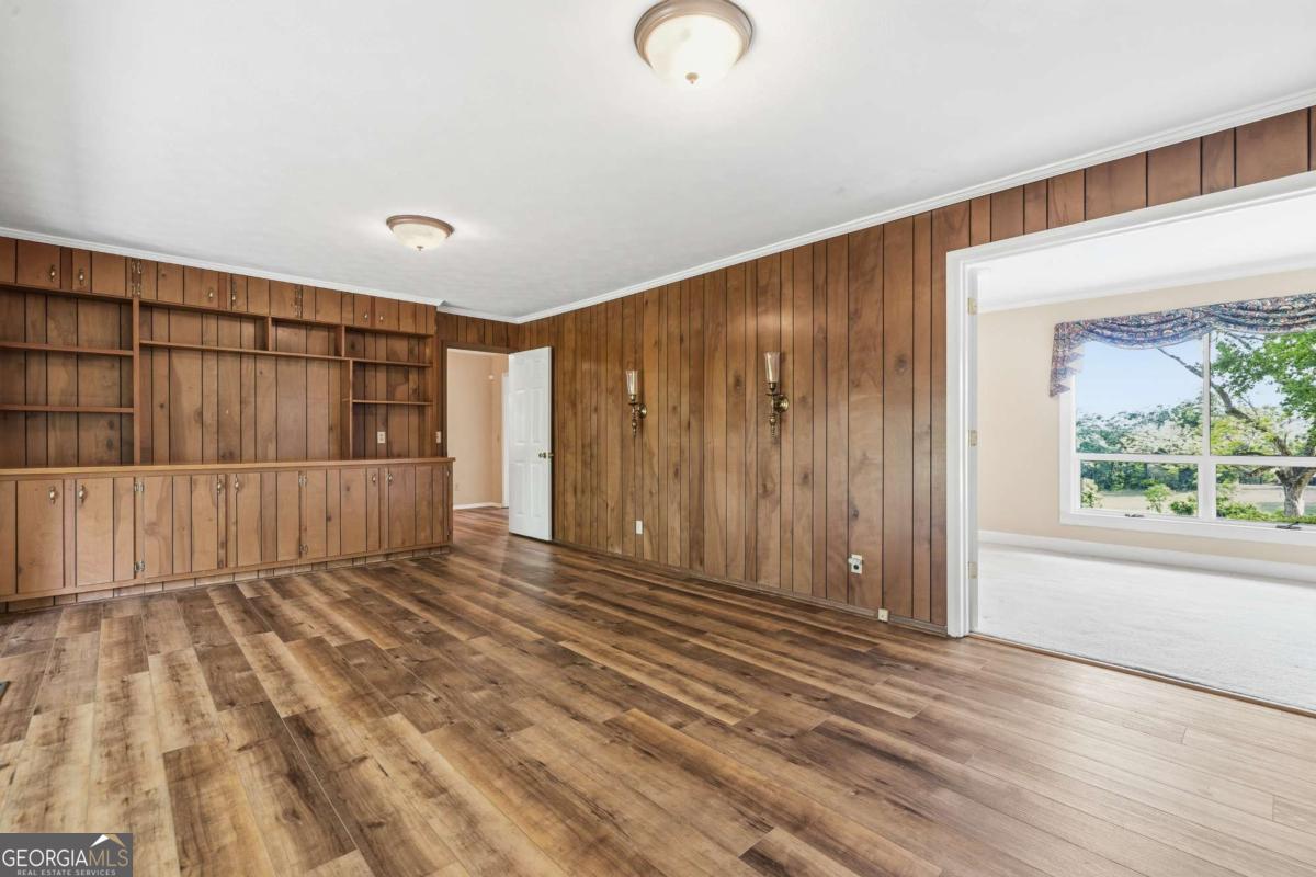 56 Claymont Road McIntyre, GA 31054 - Photo 12 of 63 a view of empty room with wooden floor and fan