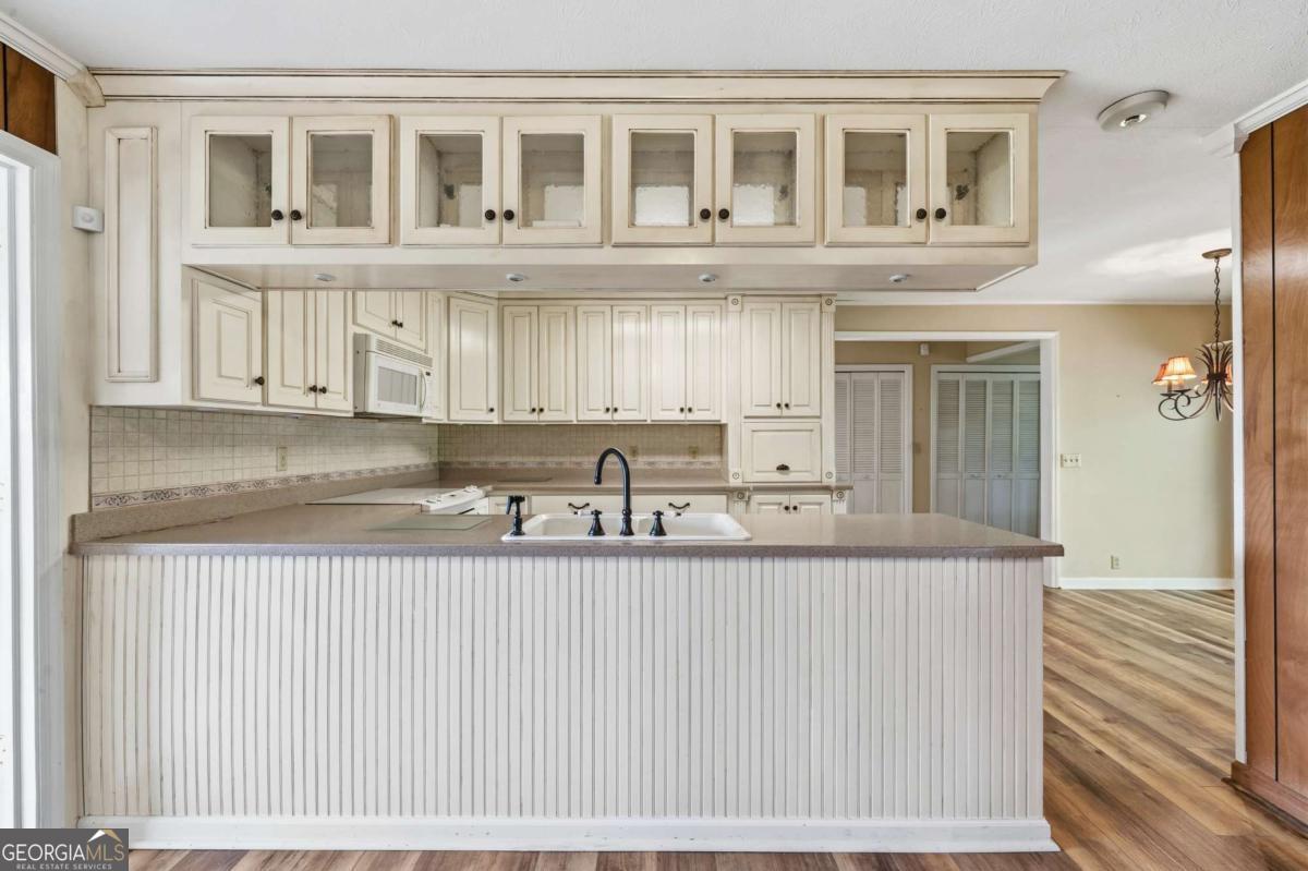 56 Claymont Road McIntyre, GA 31054 - Photo 17 of 63 a kitchen with a sink and cabinets