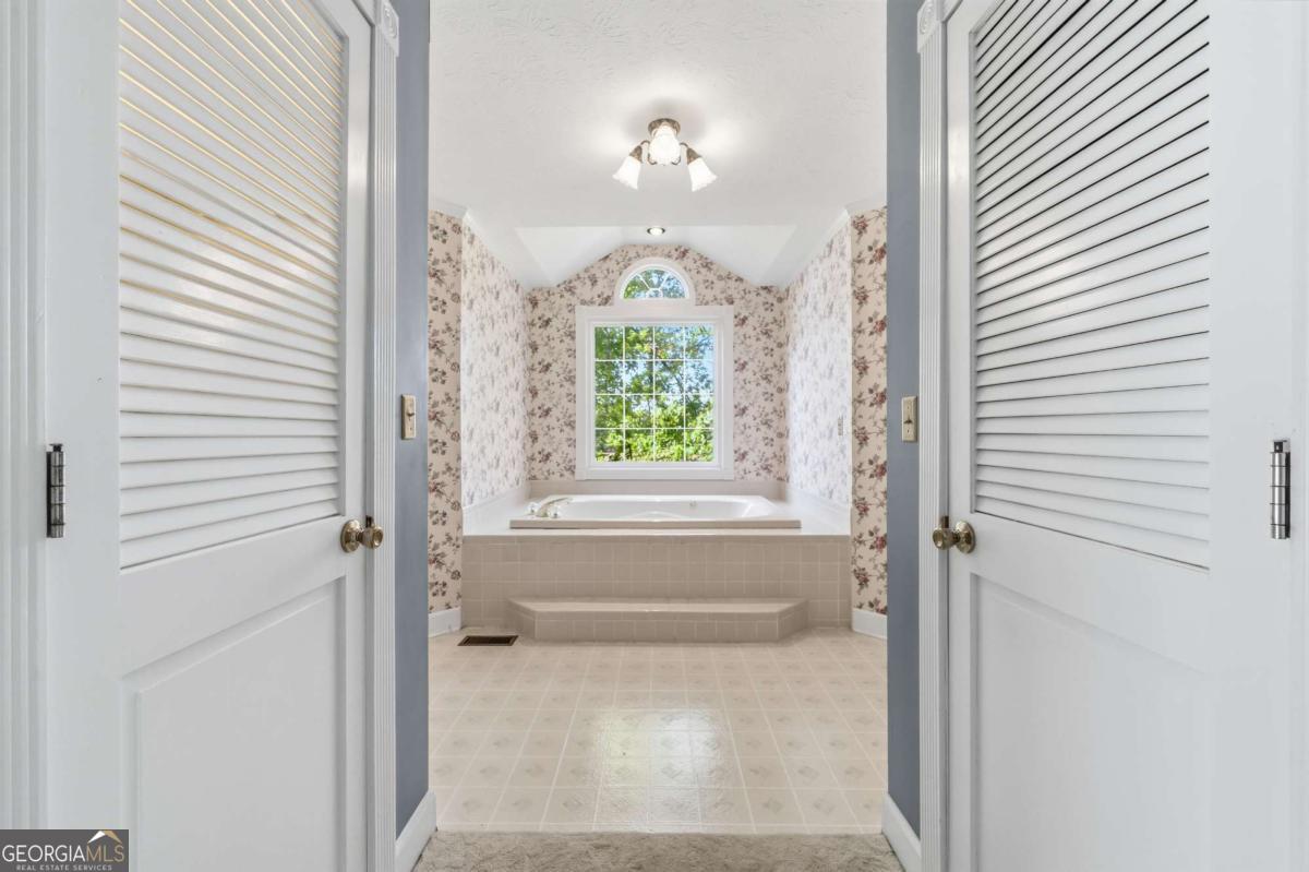 56 Claymont Road McIntyre, GA 31054 - Photo 29 of 63 a bathroom with a bathtub and windows