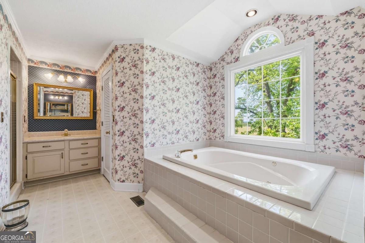 56 Claymont Road McIntyre, GA 31054 - Photo 30 of 63 a bathroom with a bathtub sink and window