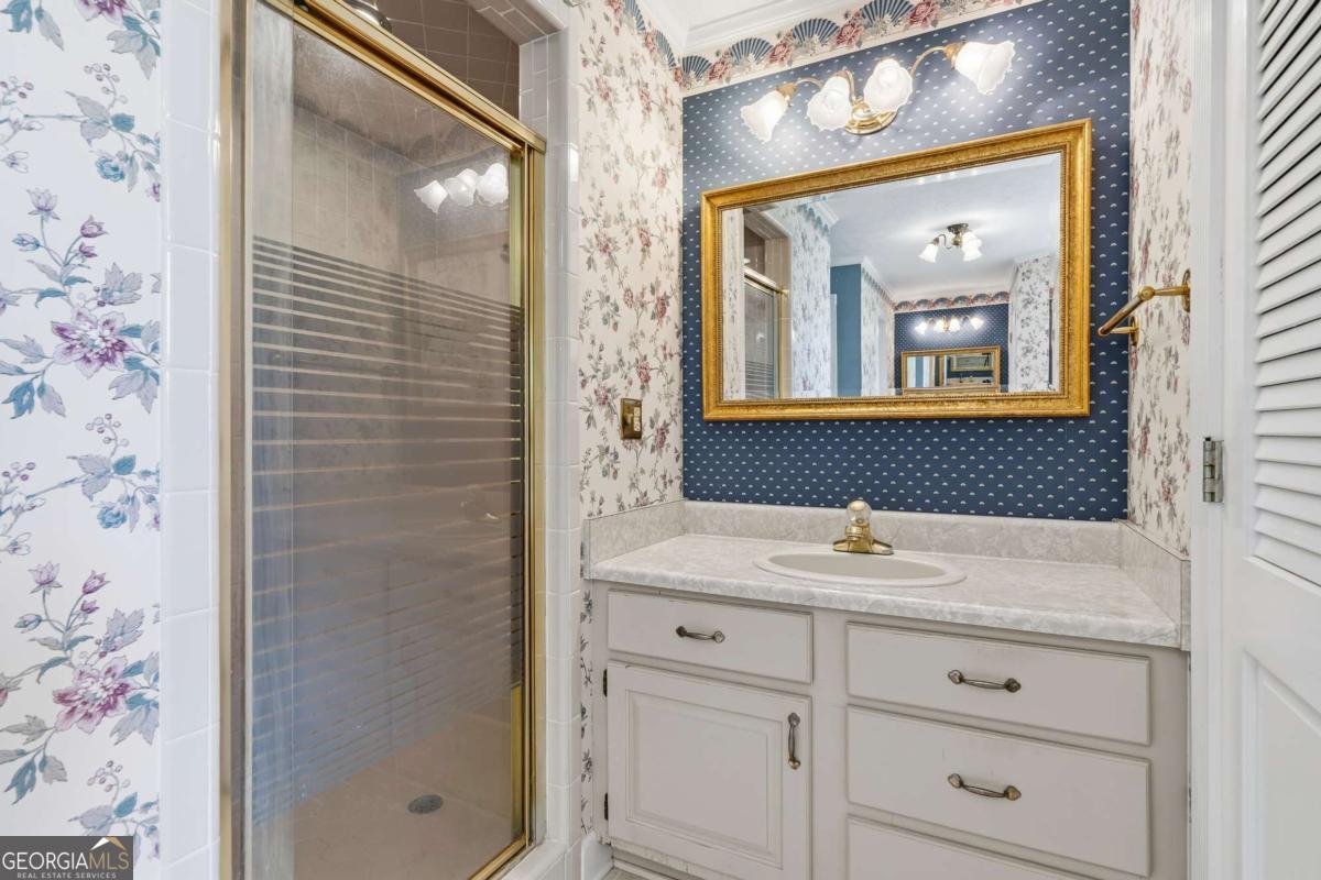 56 Claymont Road McIntyre, GA 31054 - Photo 31 of 63 a bathroom with a sink and a mirror