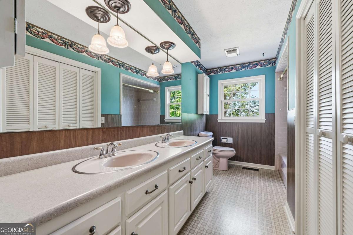 56 Claymont Road McIntyre, GA 31054 - Photo 36 of 63 a bathroom with a granite countertop sink mirror and a toilet