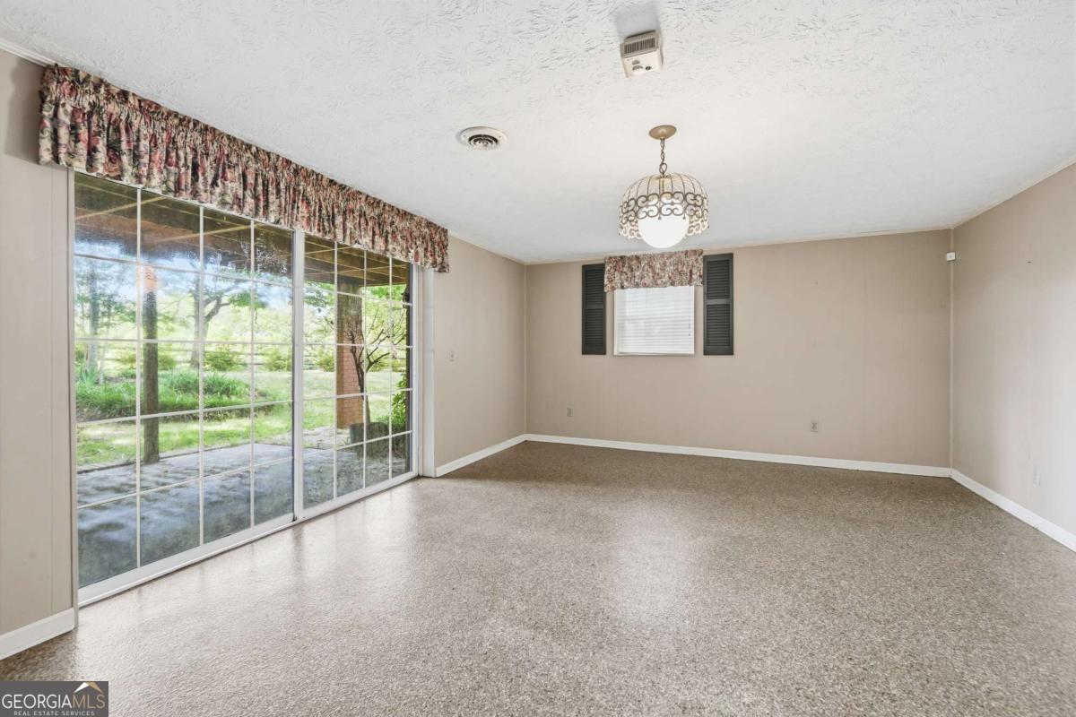 56 Claymont Road McIntyre, GA 31054 - Photo 40 of 63 en empty room with windows and outdoor view