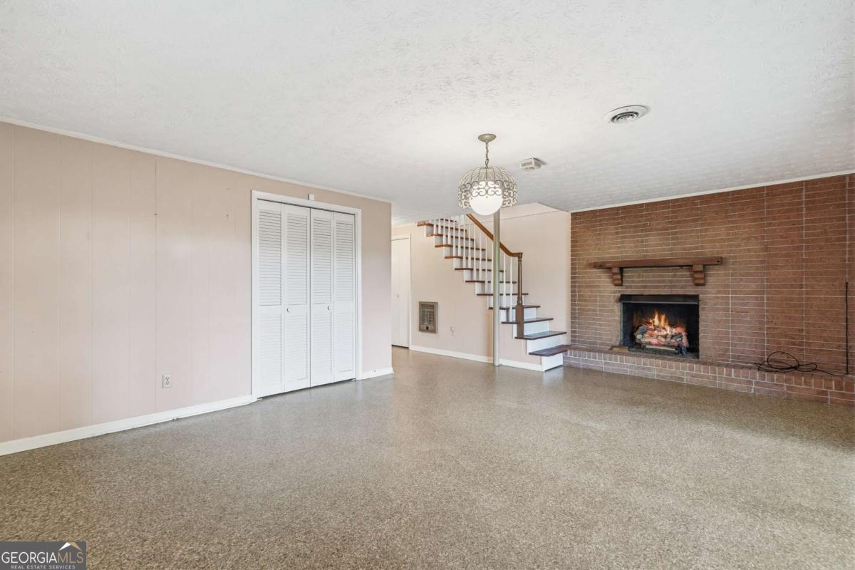 56 Claymont Road McIntyre, GA 31054 - Photo 41 of 63 a view of an empty room with a fireplace and a window