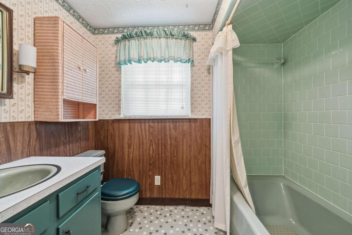 56 Claymont Road McIntyre, GA 31054 - Photo 44 of 63 a bathroom with a sink a toilet a window and shower