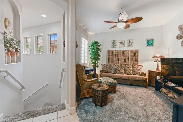 a living room with furniture a window and a flat screen tv