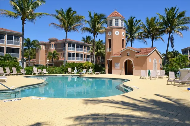a view of a house with a yard and potted plants