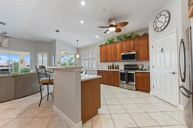 a kitchen with stainless steel appliances granite countertop a refrigerator and a stove top oven