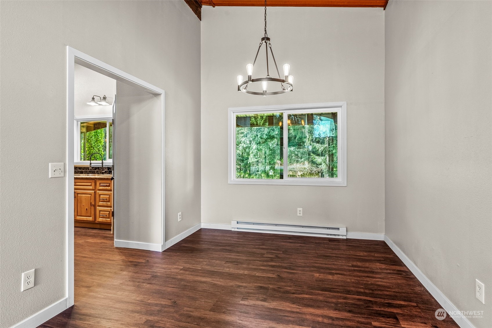 122 Fircrest Road Chehalis, WA 98532 - Photo 13 of 31 an empty room with wooden floor chandelier and windows