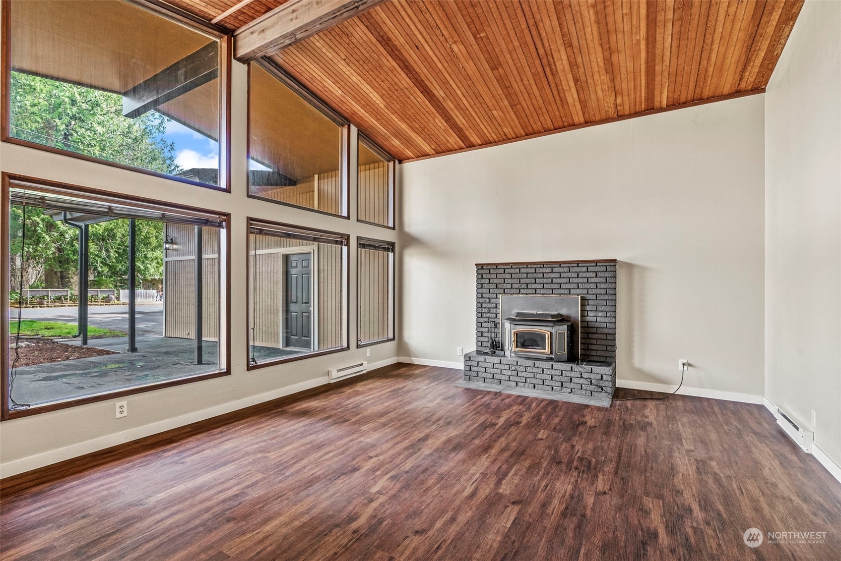 122 Fircrest Road Chehalis, WA 98532 - Photo 5 of 31 an empty room with wooden floor fireplace and windows