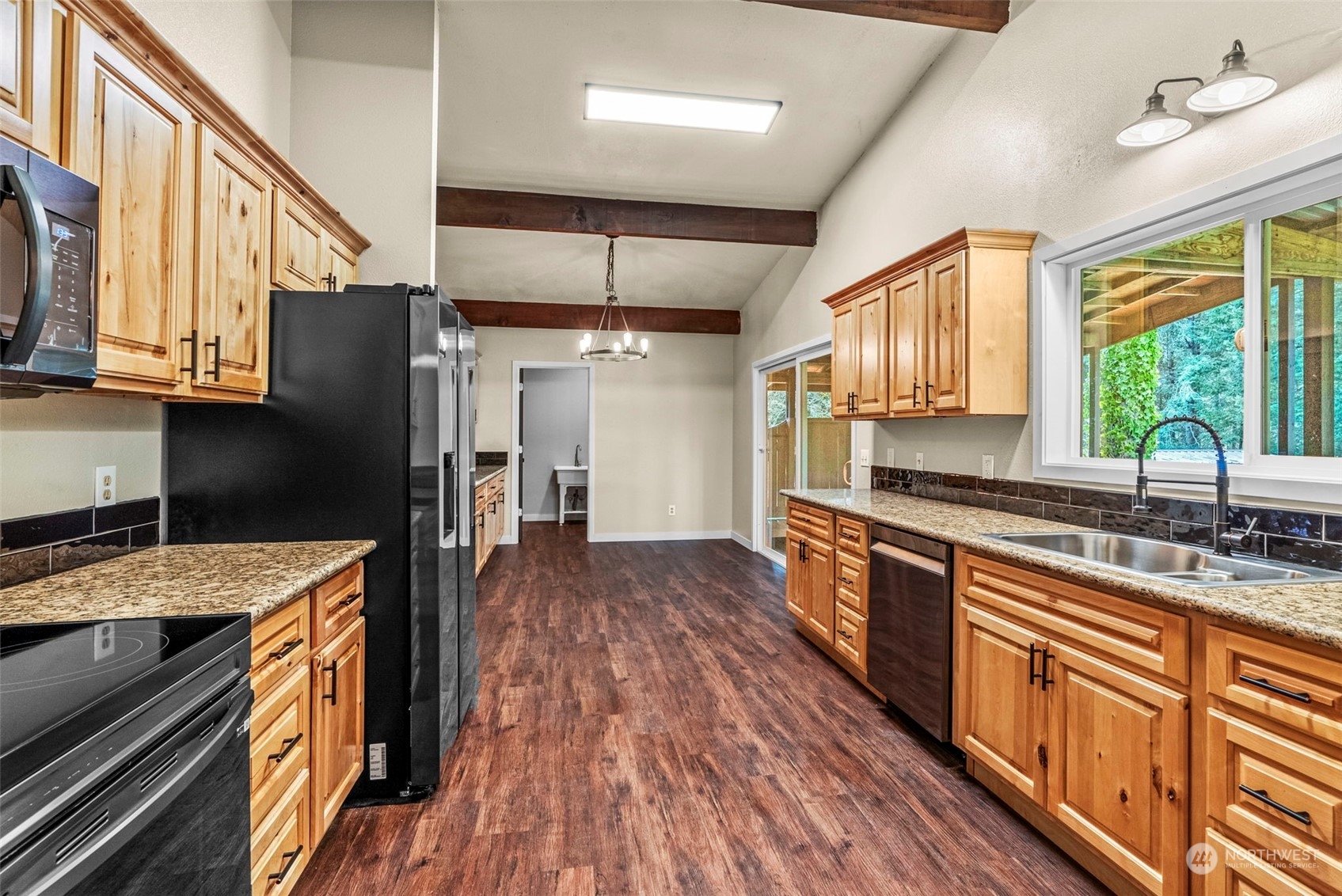 122 Fircrest Road Chehalis, WA 98532 - Photo 8 of 31 a kitchen with stainless steel appliances granite countertop a refrigerator a sink dishwasher a stove and white countertops with wooden floor