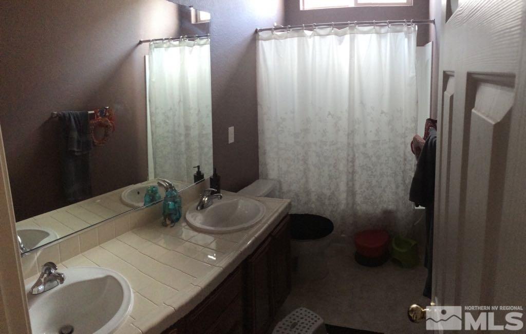 1441 Hagar Road Reno, NV 89506 - Photo 6 of 18 a bathroom with a sink and mirror