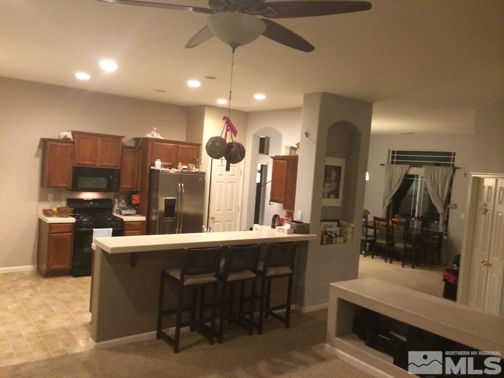 1441 Hagar Road Reno, NV 89506 - Photo 10 of 18 a kitchen with stainless steel appliances kitchen island granite countertop a sink and cabinets
