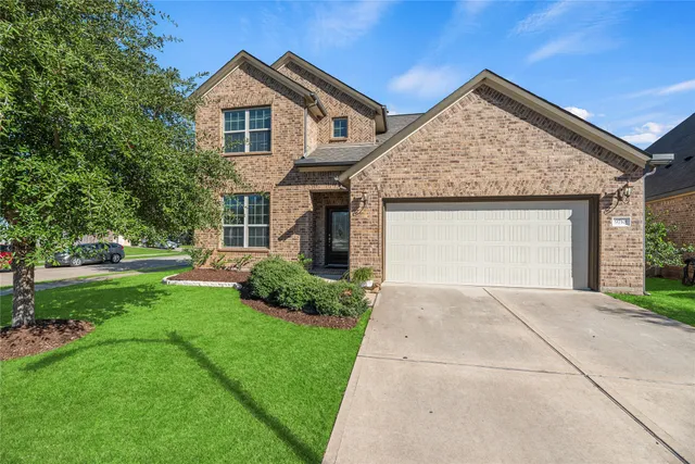a front view of a house with a yard and garage