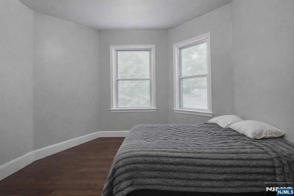 155 Myrtle Avenue Irvington, NJ 07111 - Photo 12 of 26 a bedroom with a bed and wooden floor