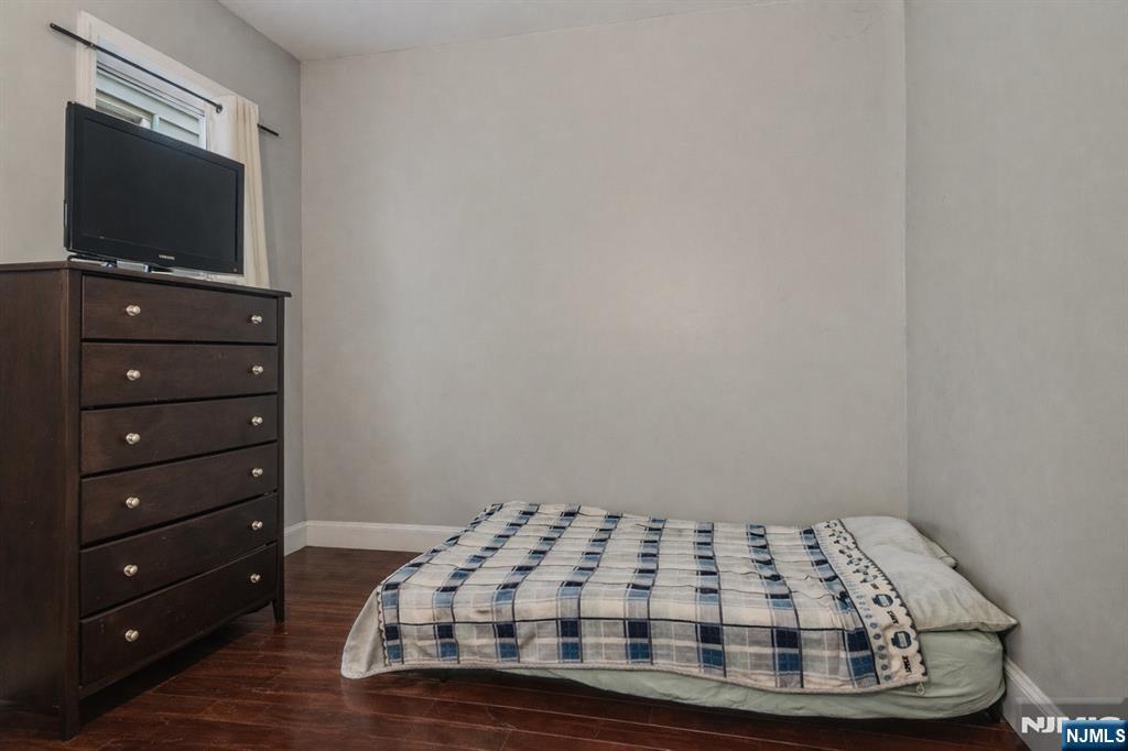 155 Myrtle Avenue Irvington, NJ 07111 - Photo 13 of 26 a bedroom with a bed and a flat screen tv