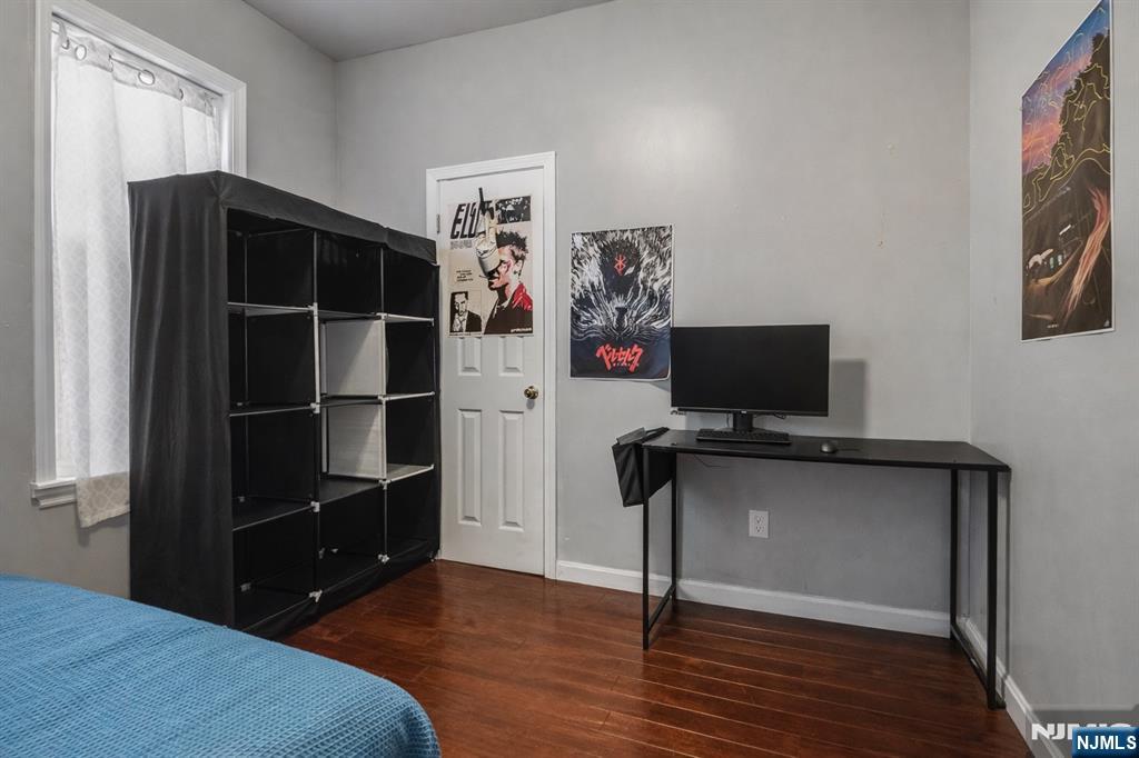 155 Myrtle Avenue Irvington, NJ 07111 - Photo 15 of 26 a bedroom with a bed and a flat screen tv