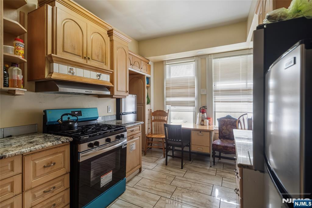 155 Myrtle Avenue Irvington, NJ 07111 - Photo 17 of 26 a kitchen with stainless steel appliances granite countertop a stove a sink and a refrigerator