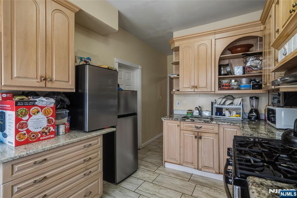 155 Myrtle Avenue Irvington, NJ 07111 - Photo 18 of 26 a kitchen with stainless steel appliances a refrigerator and a stove top oven