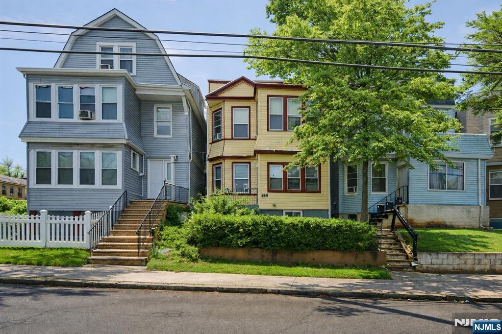 155 Myrtle Avenue Irvington, NJ 07111 - Photo 2 of 26 a front view of a house with a garden