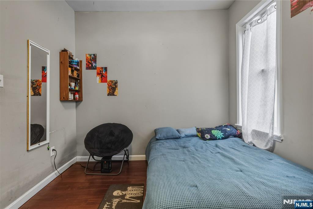 155 Myrtle Avenue Irvington, NJ 07111 - Photo 21 of 26 a bedroom with a bed and cabinets