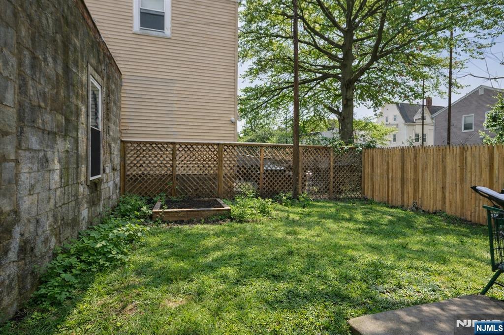 155 Myrtle Avenue Irvington, NJ 07111 - Photo 4 of 26 a view of a backyard with a garden