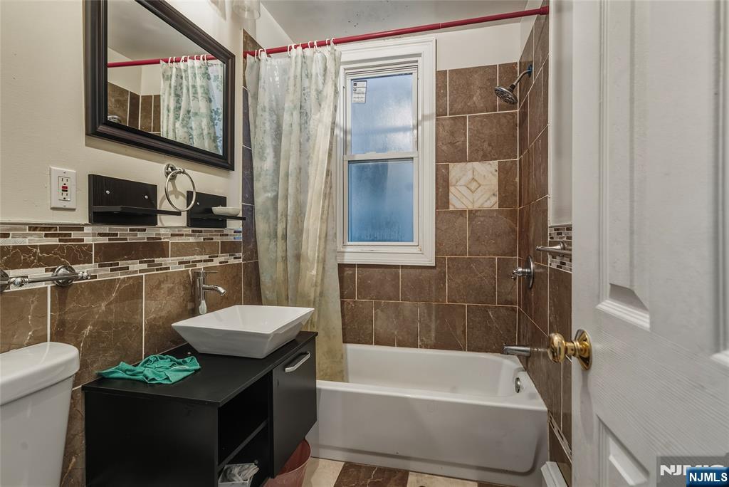 155 Myrtle Avenue Irvington, NJ 07111 - Photo 10 of 26 a bathroom with a sink a toilet and shower