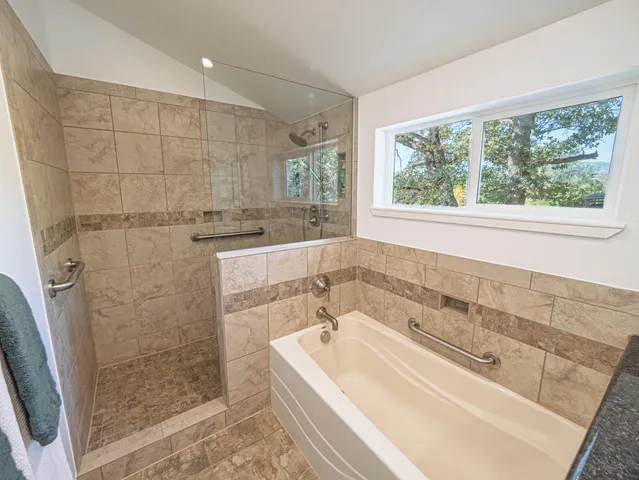 a bathroom with a bathtub and shower
