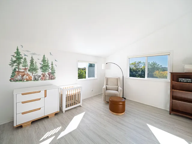 a living room with furniture a window and wooden floor