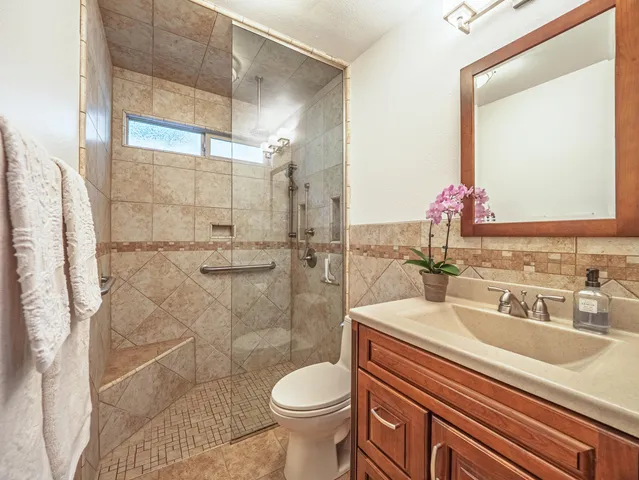 a bathroom with a sink toilet and shower