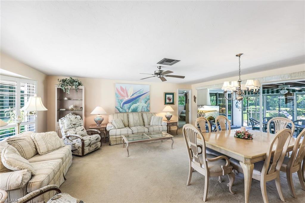 770 Anchor Rode Drive Naples, FL 34103 - Photo 13 of 26 Living / Dining combo area opening onto the screened lanai and pool