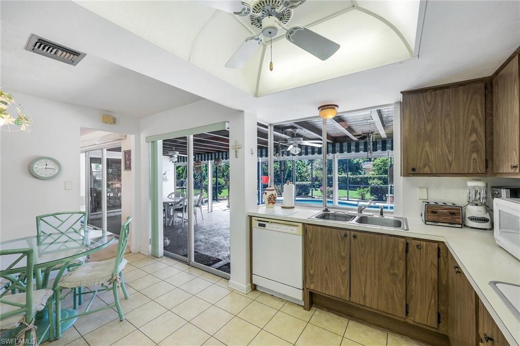 770 Anchor Rode Drive Naples, FL 34103 - Photo 16 of 26 Kitchen featuring ceiling fan, sink, white appliances, and light tile floors