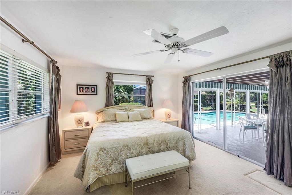 770 Anchor Rode Drive Naples, FL 34103 - Photo 17 of 26 The Primary Suite occupies one end of the home and offers direct access to the screened lanai and pool
