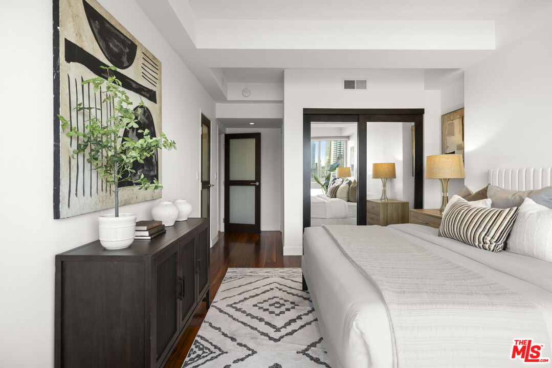 2222 Avenue Of The Stars, Unit 1004 Los Angeles, CA 90067 - Photo 11 of 25 a bedroom with a bed and a potted plant