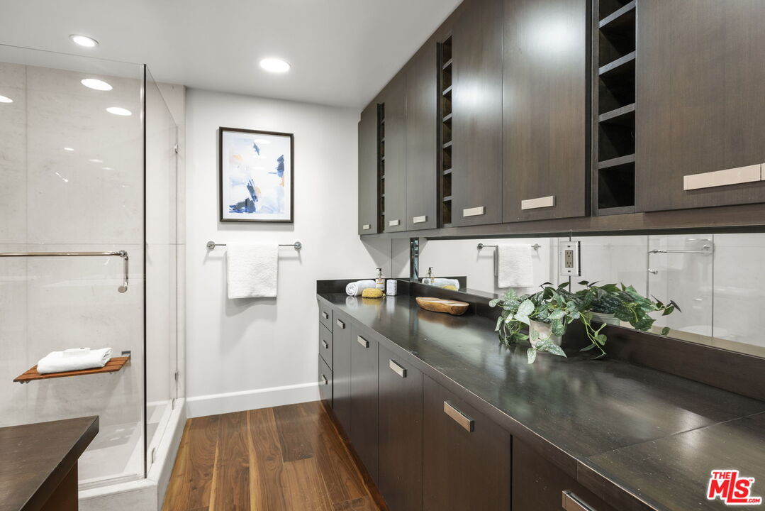2222 Avenue Of The Stars, Unit 1004 Los Angeles, CA 90067 - Photo 13 of 25 a kitchen with stainless steel appliances granite countertop a sink and a white wooden cabinets