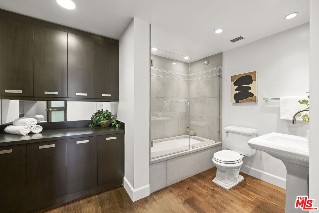2222 Avenue Of The Stars, Unit 1004 Los Angeles, CA 90067 - Photo 17 of 25 a bathroom with a sink a toilet and shower