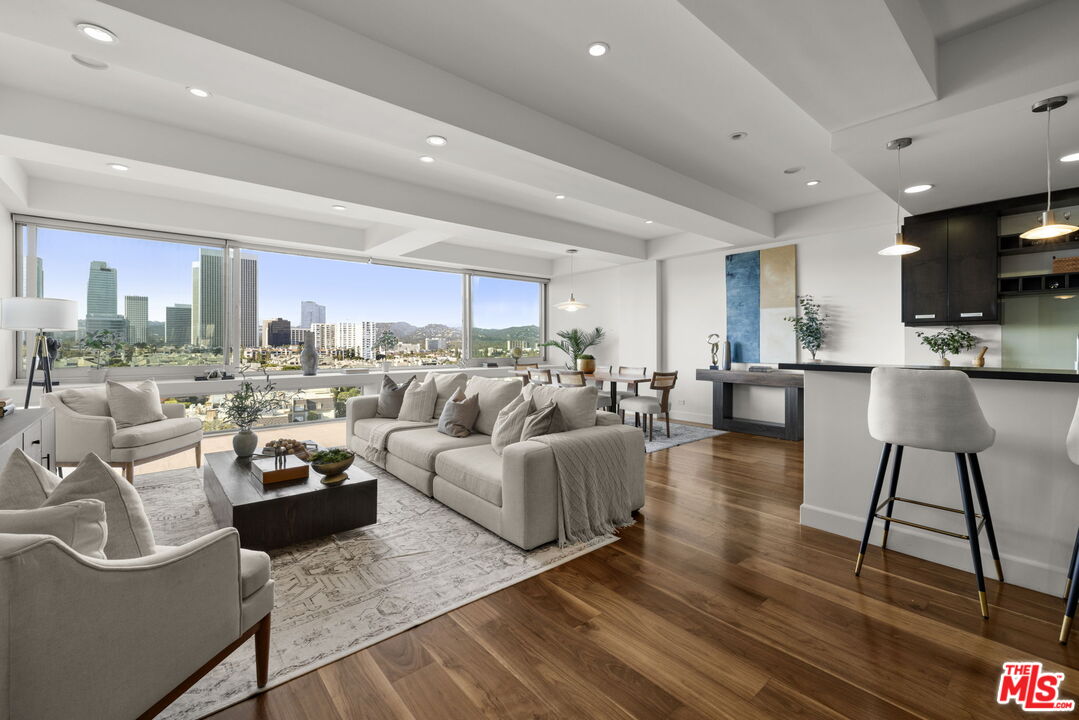 2222 Avenue Of The Stars, Unit 1004 Los Angeles, CA 90067 - Photo 2 of 25 a living room with furniture and a view of kitchen