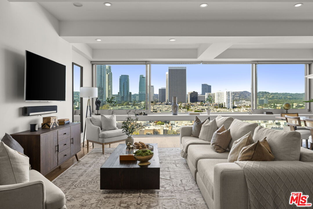 2222 Avenue Of The Stars, Unit 1004 Los Angeles, CA 90067 - Photo 3 of 25 a living room with furniture and a flat screen tv