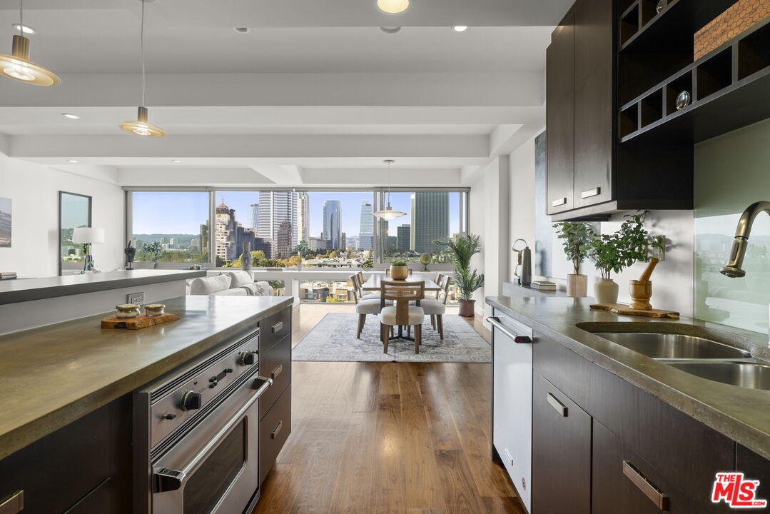 2222 Avenue Of The Stars, Unit 1004 Los Angeles, CA 90067 - Photo 7 of 25 a kitchen with stainless steel appliances a sink a stove and a wooden floors