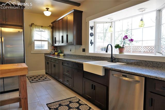 320 West Cheyenne Road Colorado Springs, CO 80906 - Photo 9 of 18 And here's where you want the modern conveniences...in a gorgeously remodeled kitchen. Ample stone counters, gorgeous cabinetry, farmhouse sink, and a bay window for your year-round herb garden.