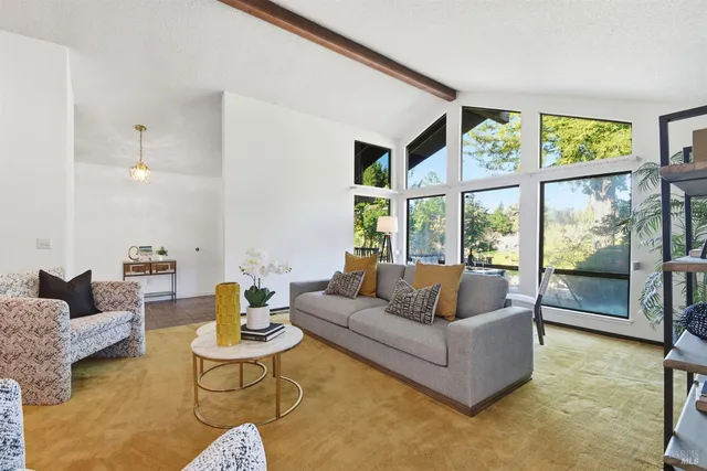 a kitchen with stainless steel appliances granite countertop a table chairs sink and cabinets