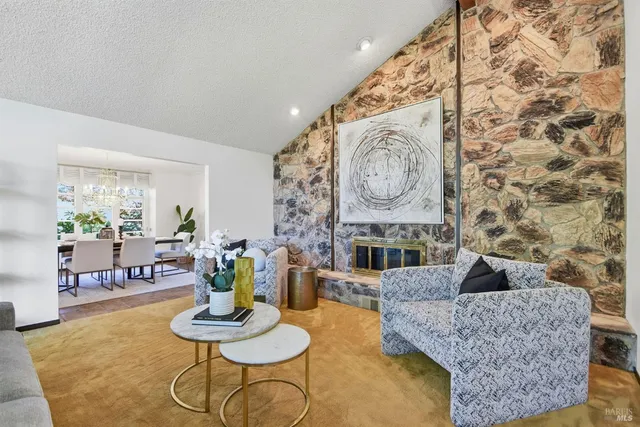 a kitchen with granite countertop a table chairs stove and cabinets