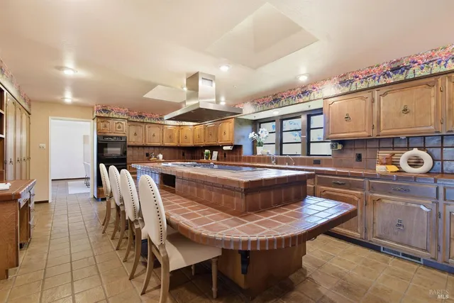 a bathroom with a granite countertop sink a mirror and shower